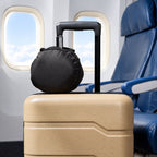 Carry pouch on a carry-on suitcase in the aisle