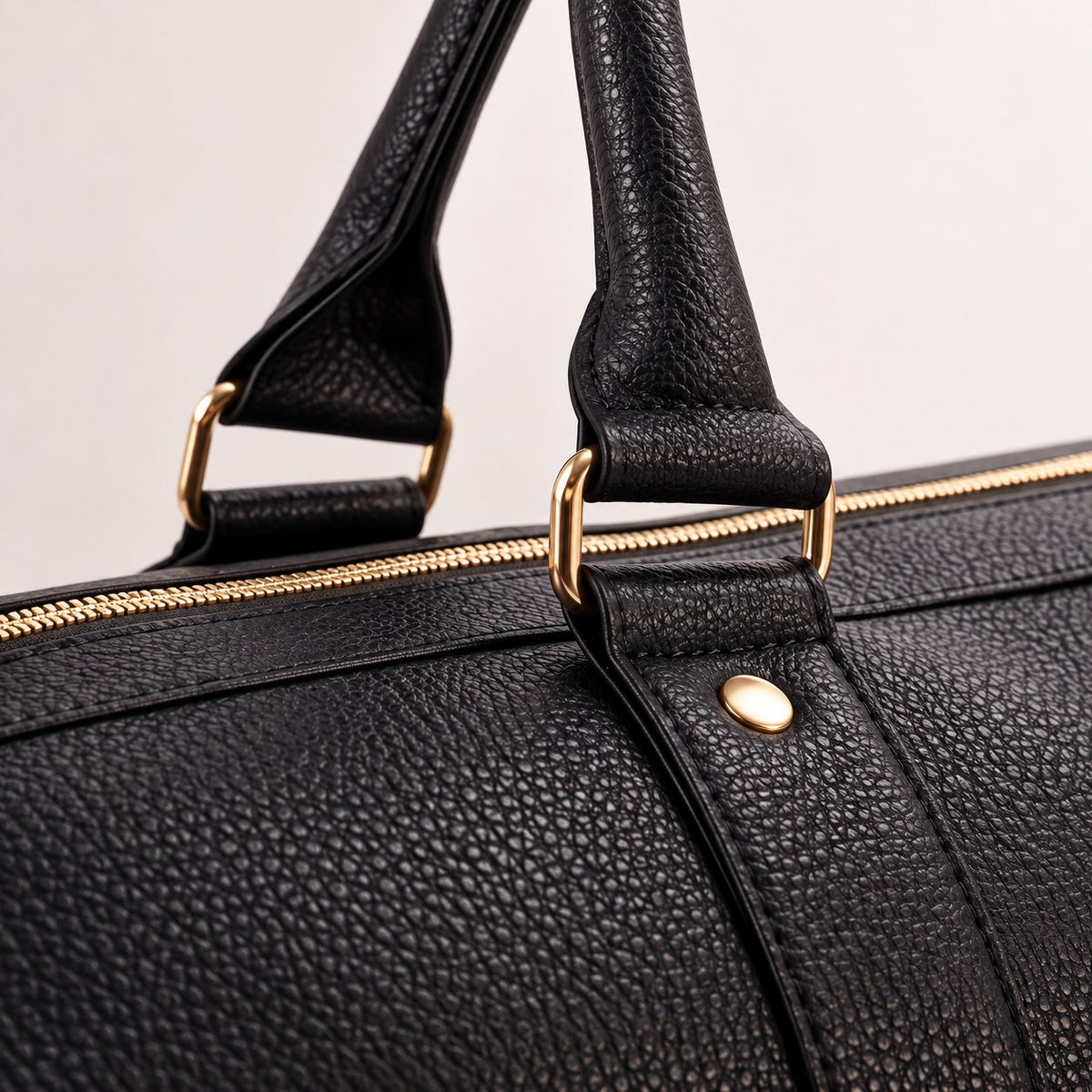 Rolled handles and gold hardware on the Black bag